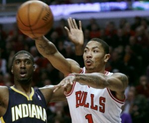 Chicago Bulls' Rose passes ball around Indiana Pacers' Hibbert during Game 1 of their NBA Eastern Conference first round playoff basketball game in Chicago